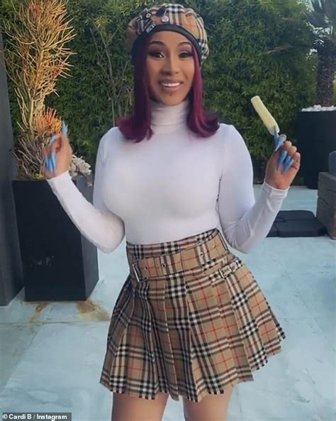 Cardi B wears a matching Burberry skirt and hat with 